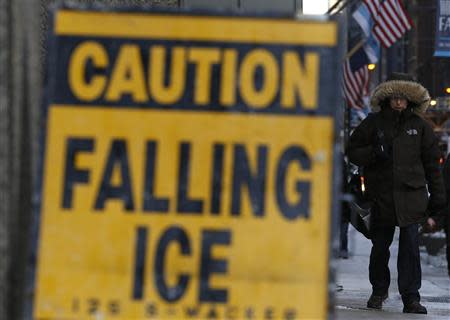 A man walks on a street on another day of frigid temperatures in downtown Chicago, Illinois, January 8, 2014. REUTERS/Jim Young