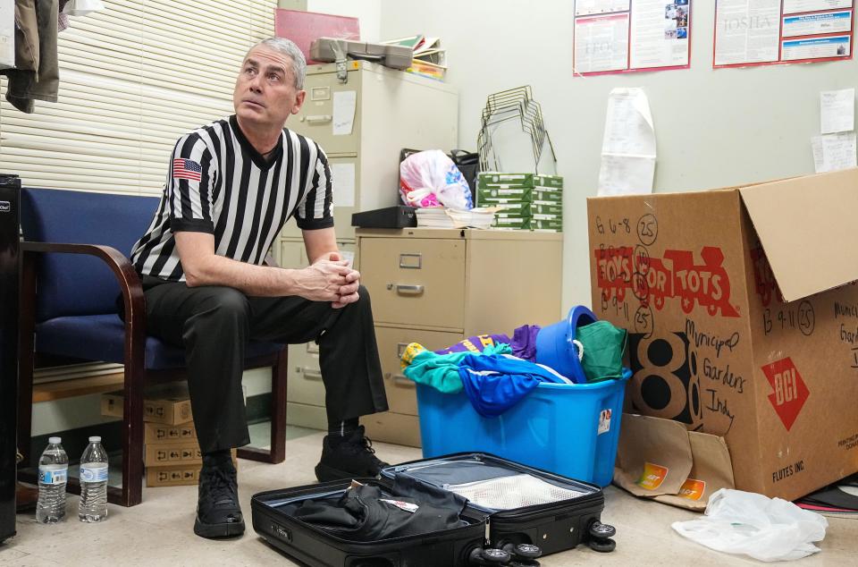 Casey Gaynor waits in an office during half-time Tuesday, Jan. 2, 2024, during the game at Municipal Gardens in Indianapolis. Gaynor, a high school basketball official, completed his journey to officiate a game at every high school in the state.