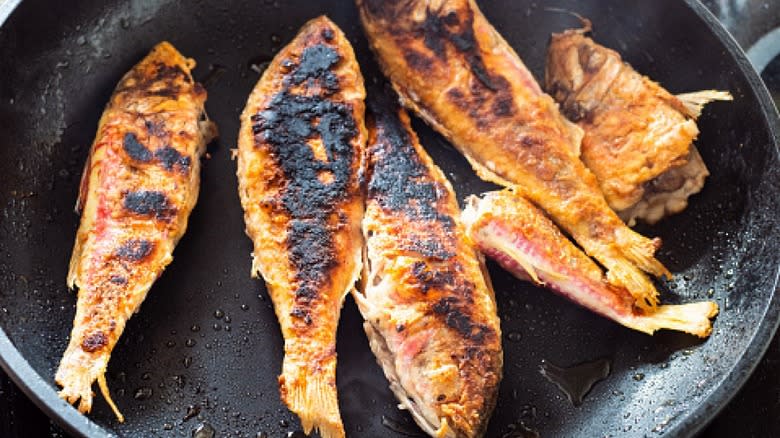 burnt fish in skillet