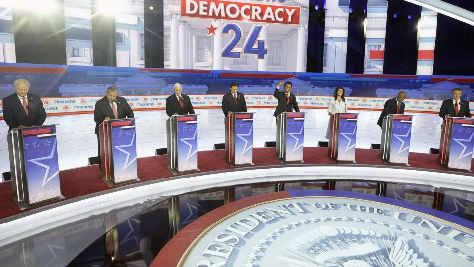 FILE - Republican presidential candidates, from left, former Arkansas Gov. Asa Hutchinson, former New Jersey Gov. Chris Christie, former Vice President Mike Pence, Florida Gov. Ron DeSantis, businessman Vivek Ramaswamy, former U.N. Ambassador Nikki Haley, Sen. Tim Scott, R-S.C., and North Dakota Gov. Doug Burgum stand on stage before a Republican presidential primary debate hosted by FOX News Channel, Aug. 23, 2023, in Milwaukee. (AP Photo/Morry Gash, File)