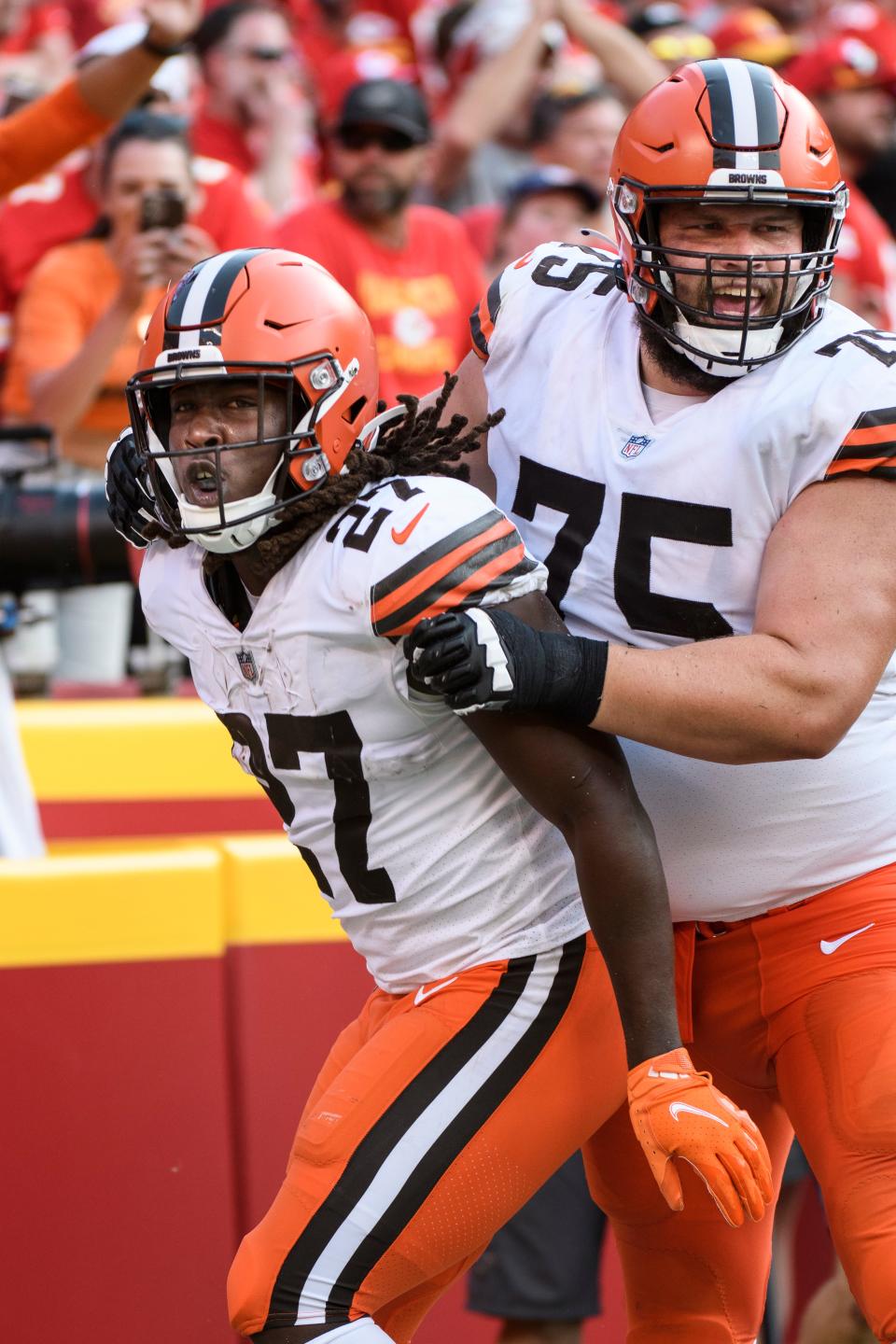 Cleveland Browns running back Kareem Hunt (27) and teammate offensive guard Joel Bitonio (75) celebrate after Hunt scored a touchdown against the Kansas City Chiefs during the second half of an NFL football game, Sunday, Sept.12, 2021 in Kansas City, Mo. (AP Photo/Reed Hoffmann)