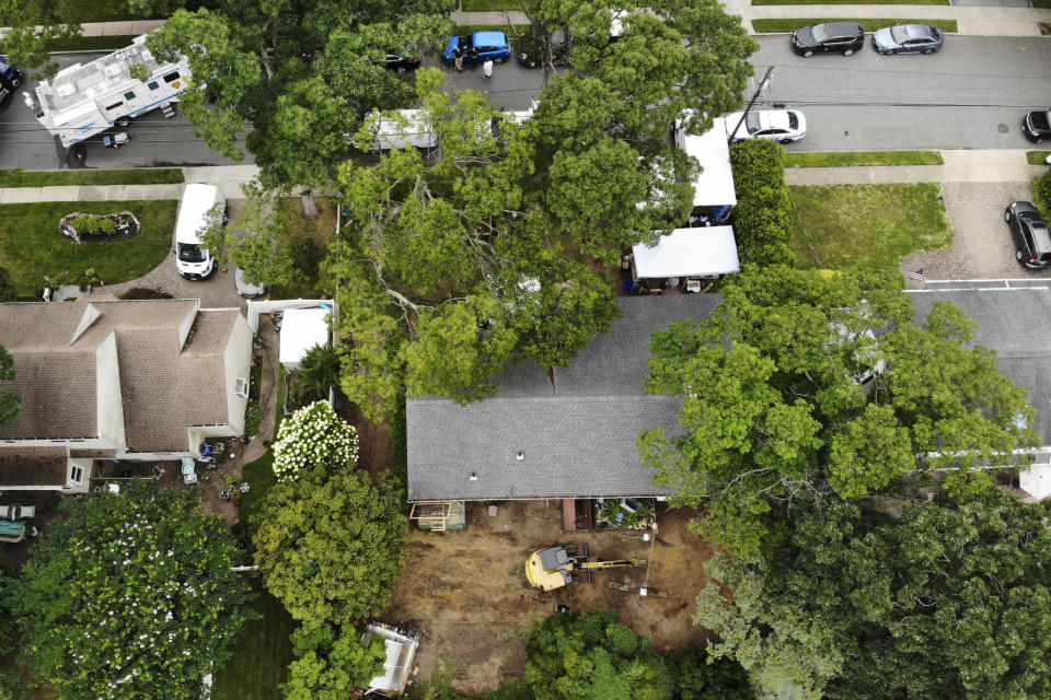 Authorities continue to work at the home of suspect Rex Heuermann, bottom, in Massapequa Park, N.Y., Monday, July 24, 2023. Heuermann has been charged with killing at least three women in the long-unsolved slayings known as the Gilgo Beach killings. (AP Photo/Seth Wenig)