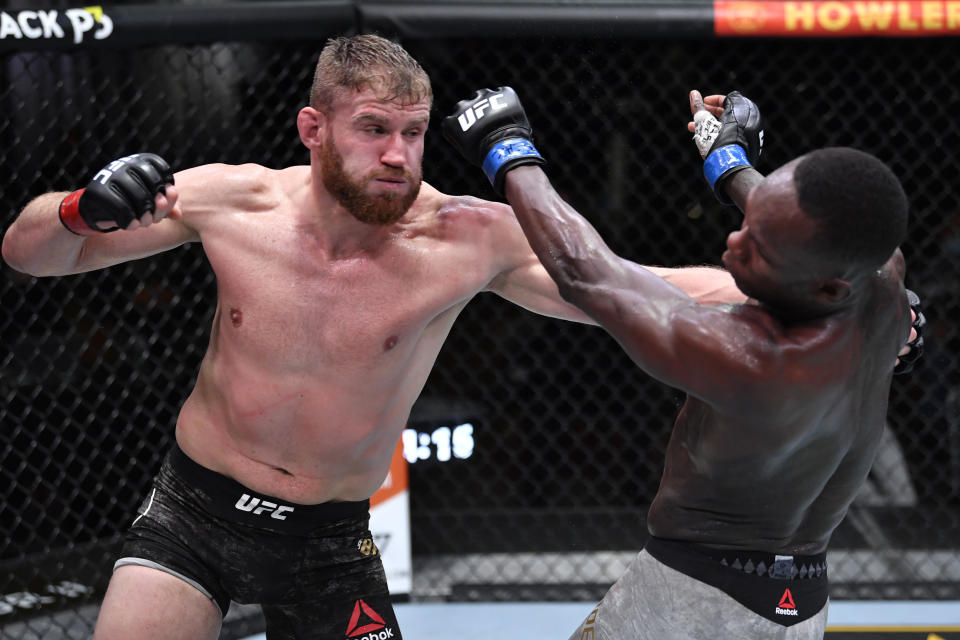 LAS VEGAS, NEVADA - MARCH 06: (L-R) Jan Blachowicz of Poland punches Israel Adesanya of Nigeria in their UFC light heavyweight championship fight during the UFC 259 event at UFC APEX on March 06, 2021 in Las Vegas, Nevada. (Photo by Jeff Bottari/Zuffa LLC)