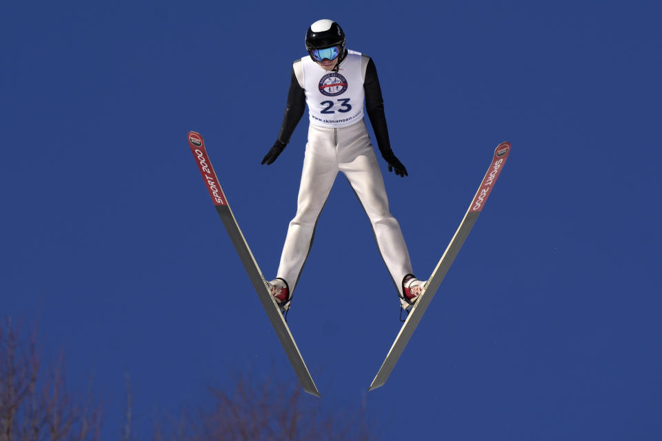 Ski jumper Mychal Reynolds, 16, of Andover, N.H., positions himself for an aerodynamic flight on his way to winning the Eastern Ski Jumping Meet, Sunday, Jan. 21, 2024, in Milan, N.H. (AP Photo/Robert F. Bukaty)