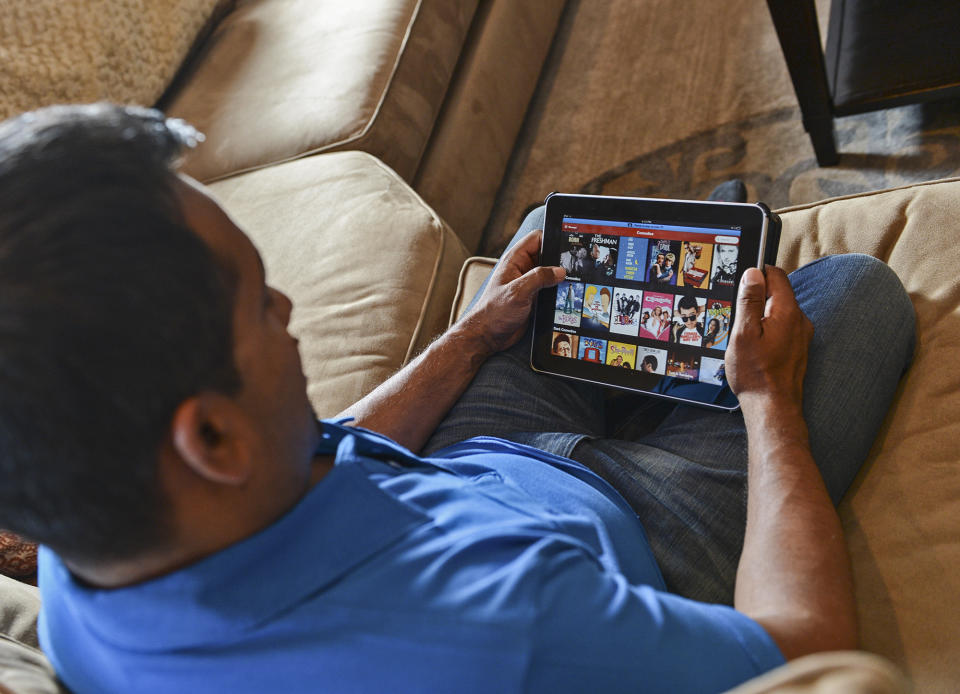 TORONTO, ON - MAY 16:  Netflix user Curtis Khan poses for a photo with his tablet where he often accesses his Netflix account, Thursday MAY 16.  For Marc Saltzman feature on the rise of services like Netflix that are either cheap or free.        (Tara Walton/Toronto Star via Getty Images)