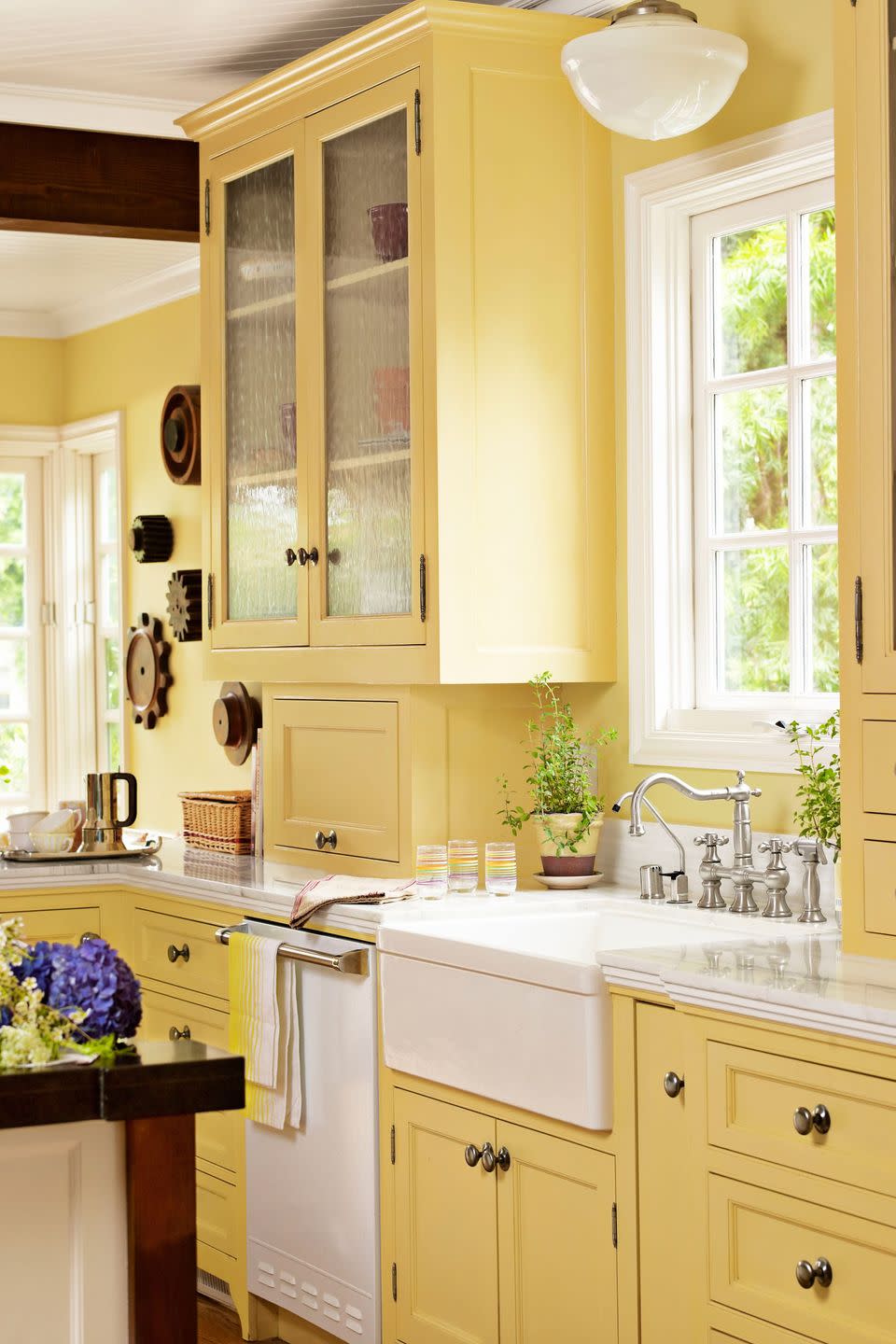 farmhouse kitchen with bright yellow cabinets, walls, and breakfast nook