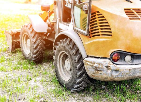 Yellow Regrade Machine on water logged Lawn