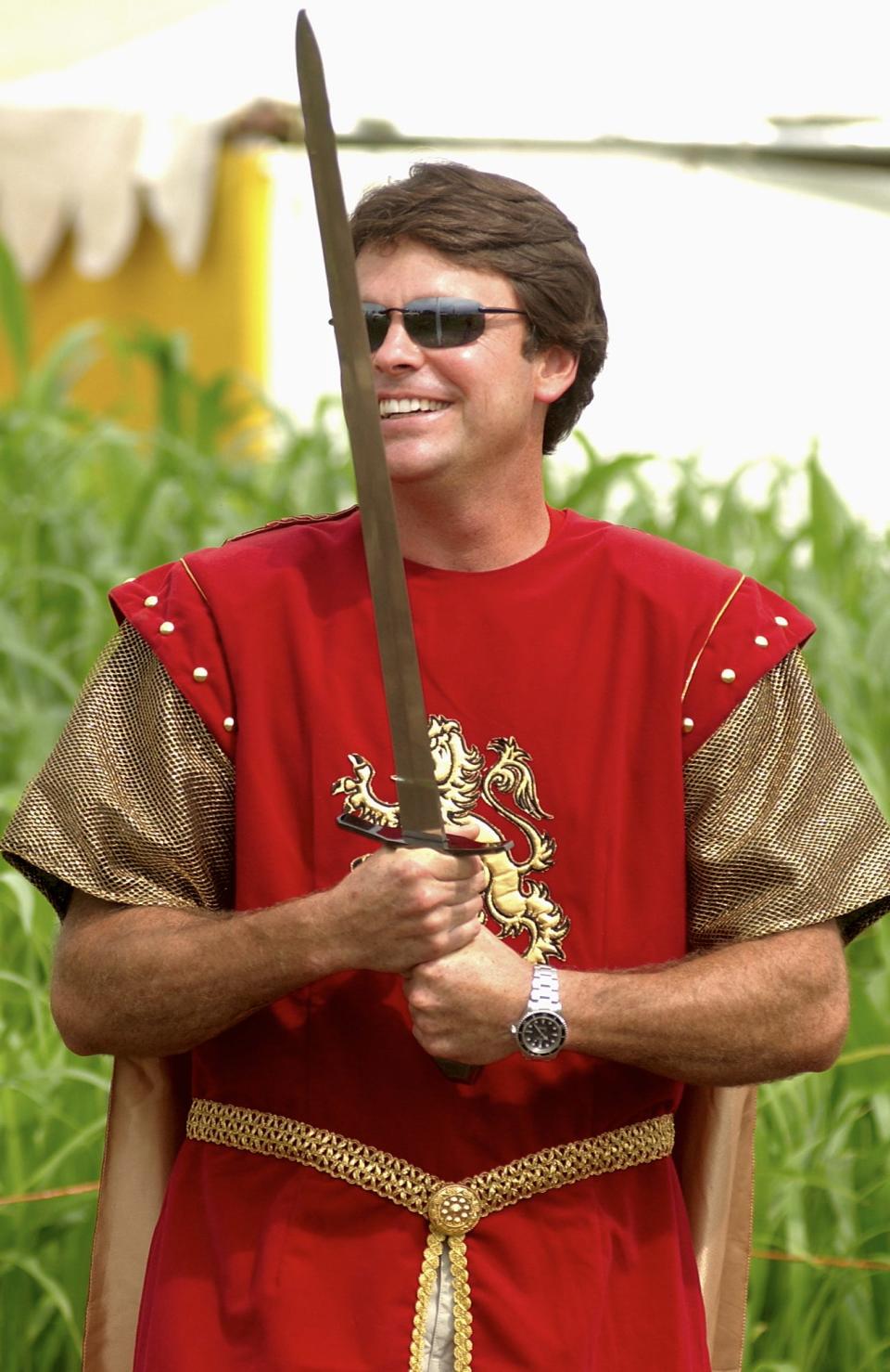 Larry Davis wields a sword during the opening day at Davis Mega Maze in Sterling on Aug. 7, 2003.