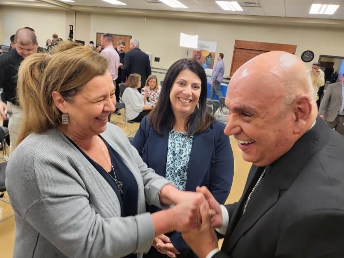 Houma-Thibodaux's newly named Catholic bishop, Mario E. Dorsonville, talks with diocese employees Holly Becnel, left, and Melissa Robertson after a news conference announcing his appointment Wednesday, Feb. 1, 2023, at the diocese offices in Schriever.