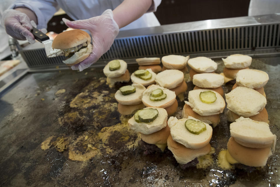 A cook prepares the Yankees Dingers, served at Frank's RedHot Terrace, during a media tour of Yankee stadium, Tuesday, April 4, 2017, in New York. The New York Yankees home-opener at the ballpark is scheduled for Monday, April 10, 2017, against the Tampa Bay Rays. (AP Photo/Mary Altaffer)