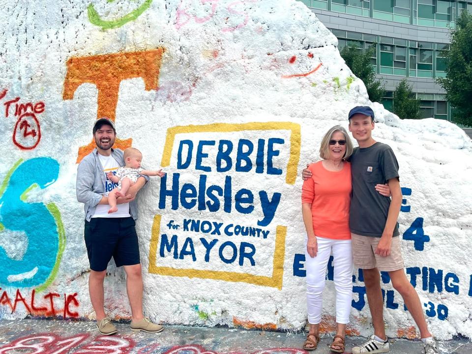 Debbie Helsley was surprised by her team at the UT Rock on July 5, 2022. From left: Matt Shears, chair of the Knox County Democratic Party, with his son Henry; Helsley, and Jack Vaughan, campaign manager.
