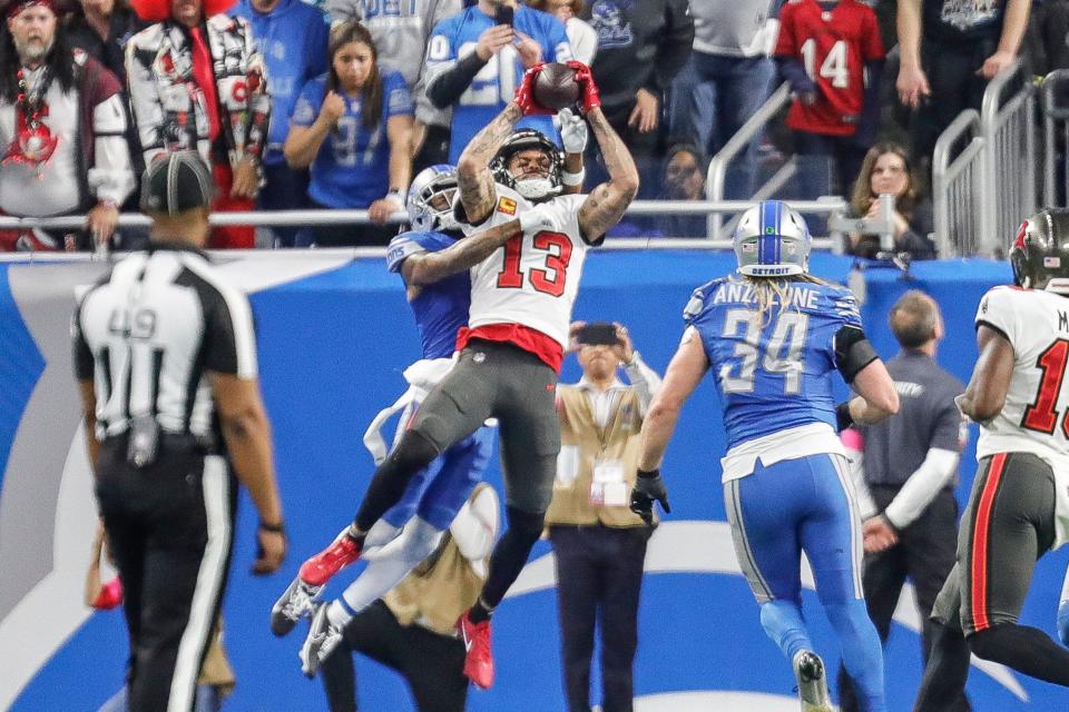 Tampa Bay Buccaneers wide receiver Mike Evans (13) makes a catch for a touchdown against Detroit Lions cornerback Cameron Sutton (1) during the second half of the NFC divisional round at Ford Field in Detroit on Sunday, Jan. 21, 2024.