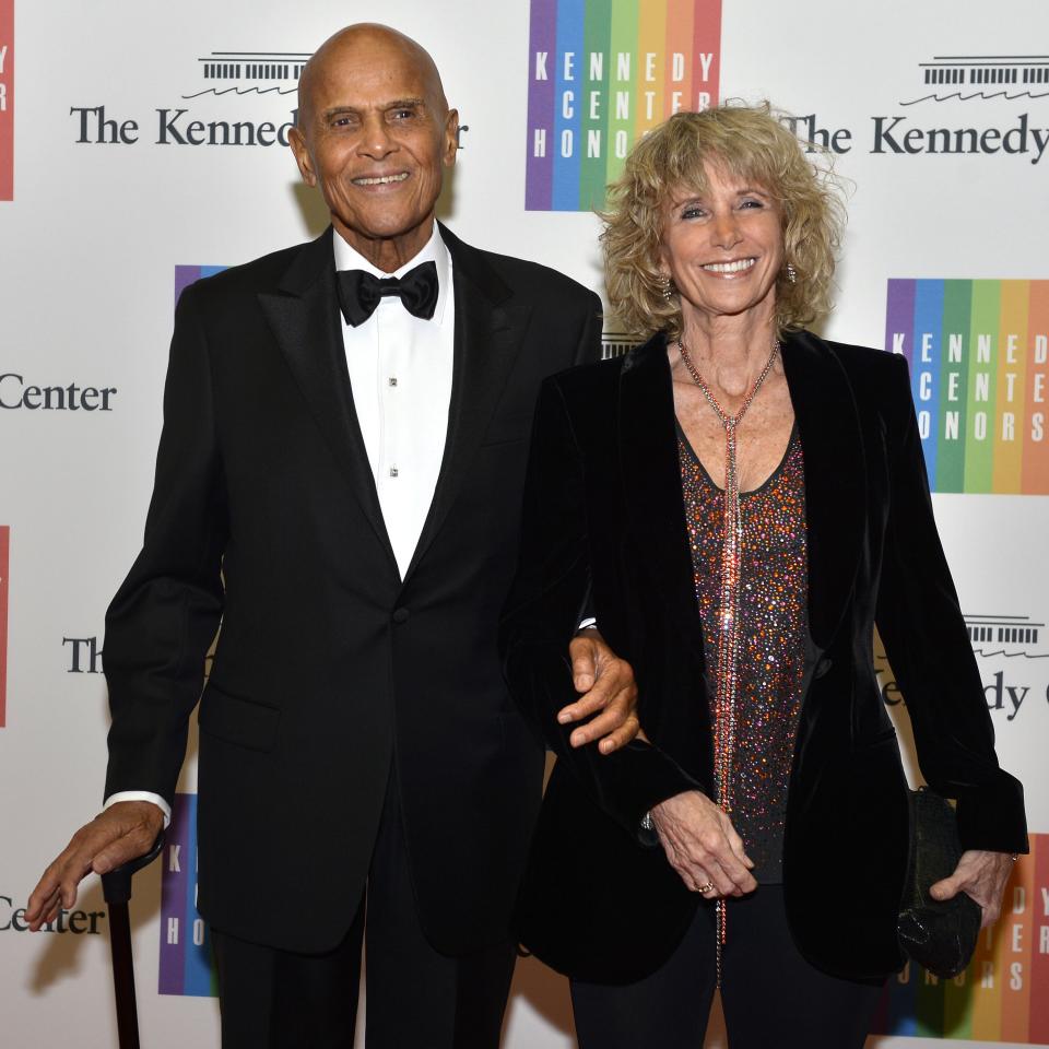 Singer-songwriter and social activist Harry Belafonte, 86, and his wife Pamela Frank pose for photographers as they arrive at the U.S. State Department for a gala dinner to honor the 2013 Kennedy Center Honorees, in Washington