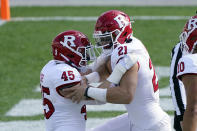 Rutgers quarterback Johnny Langan (21) is congratulated by tight end Brandon Myers (45) after his 1-yard touchdown during the first half of an NCAA college football game against Michigan State, Saturday, Oct. 24, 2020, in East Lansing, Mich. (AP Photo/Carlos Osorio)