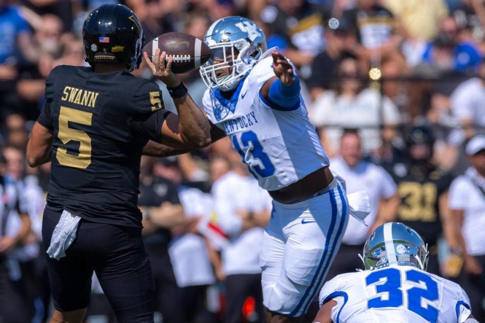 Kentucky linebacker J.J. Weaver (13) pressures Vanderbilt quarterback AJ Swann (5) during Saturday’s game at FirstBank Stadium in Nashville. Kentucky’s defense had one sack and made three interceptions, returning two of them for touchdowns.