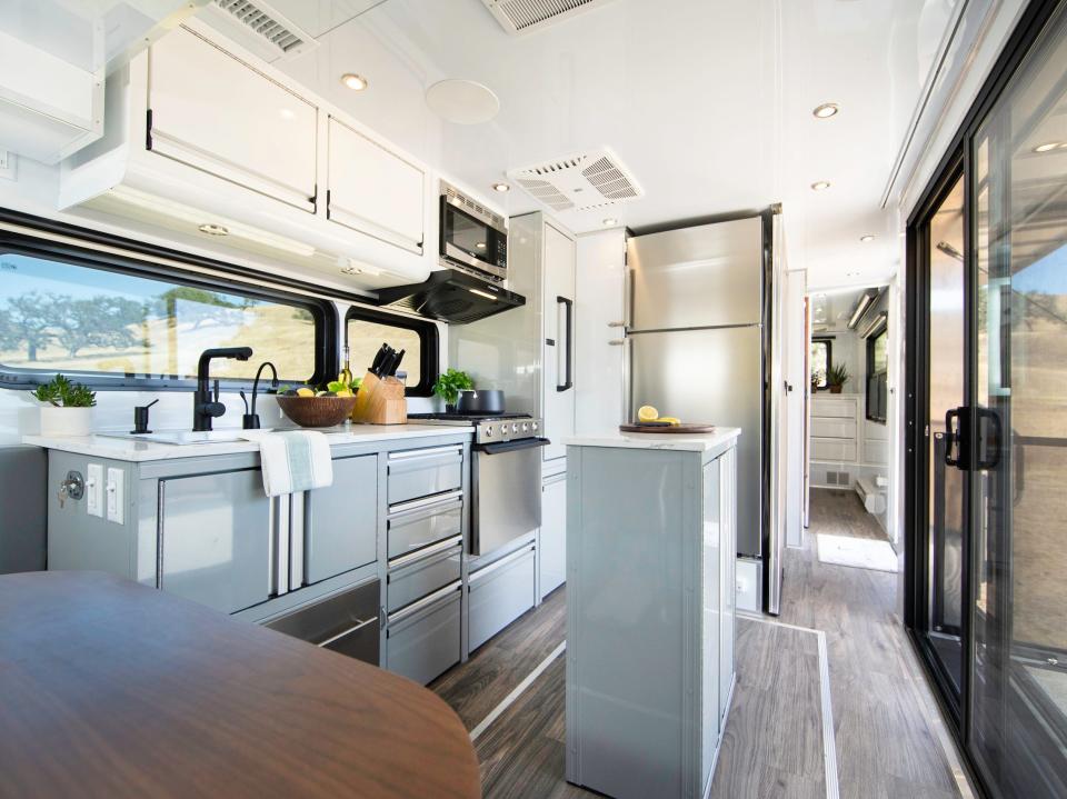 The interior kitchen and living room next to a sliding door that opens onto a patio.