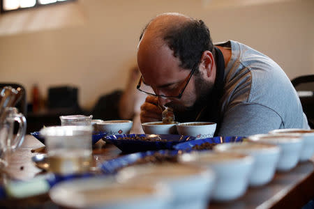 Luis Rodriguez tastes roasted coffee at El Borbollon coffee mill in Santa Ana, El Salvador on May 25, 2018. Picture taken on May 25, 2018. REUTERS/Jose Cabezas