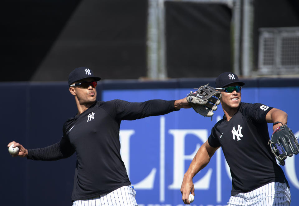 New York Yankees outfielders Giancarlo Stanton, left, and Aaron Judge, warm up before the team's spring training baseball game against the Toronto Blue Jays in Tampa, Fla., Wednesday, March 30, 2022. (Mark Taylor/The Canadian Press via AP)