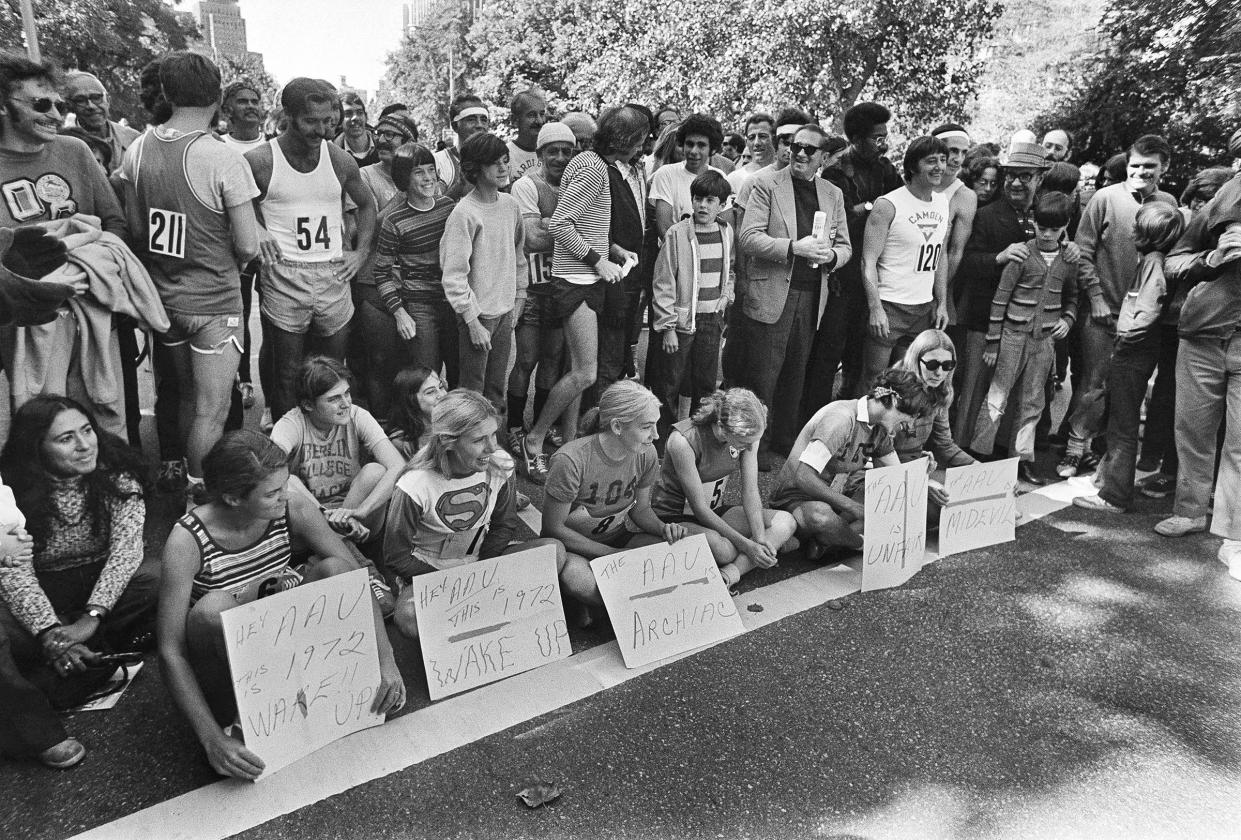 Six women officially in the New York City Marathon sit in protest at the start of the marathon in New York.