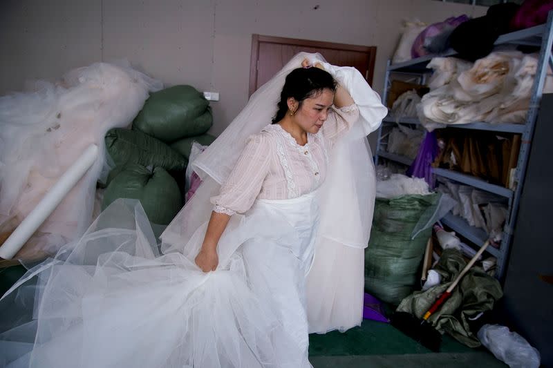 The Wider Image: Coronavirus dampens celebrations in China's wedding gown city