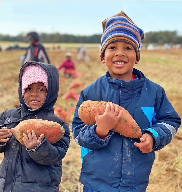 Two of the Brown children with sweet potatoes