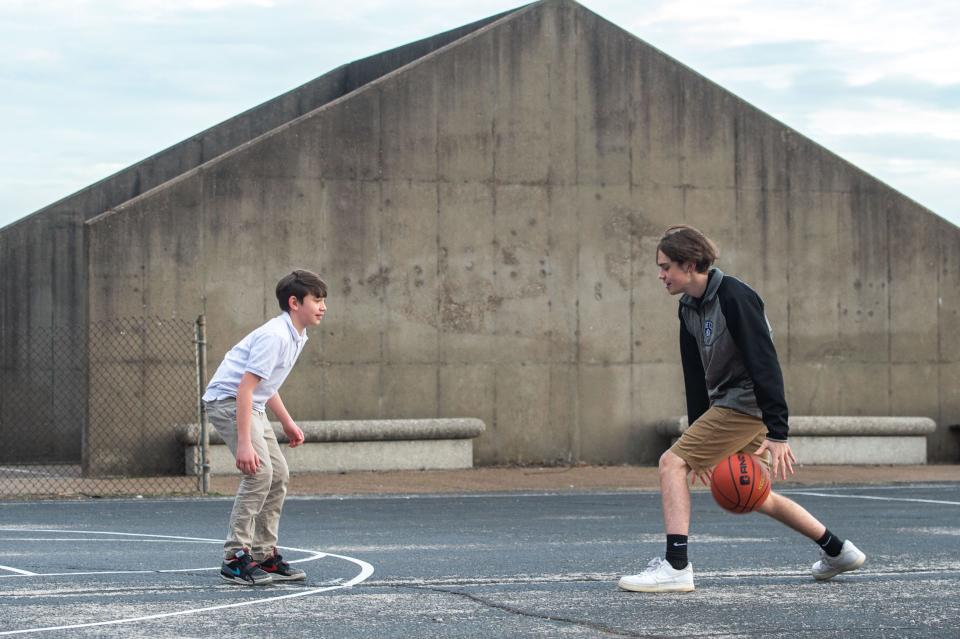 Jadon Chamberlin, 17, right, plays basketball with younger brother Mason, 12, left, at Wesselman Park in Evansville, Ind., Wednesday afternoon, March 8, 2023.