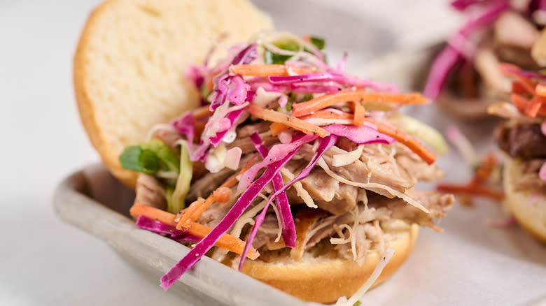 pulled pork sandwich with coleslaw on tray