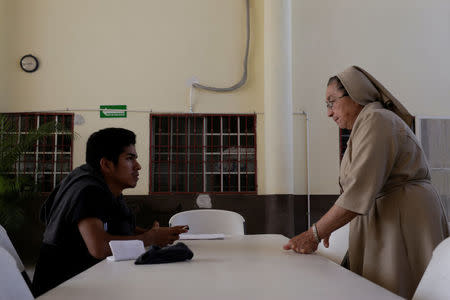 Mexican deportee Alberto talks to sister Maria Nidelvia at Our Lady of Guadalupe migrant shelter in Reynosa, Mexico March 14, 2017. Picture taken March 14, 2017. REUTERS/Daniel Becerril