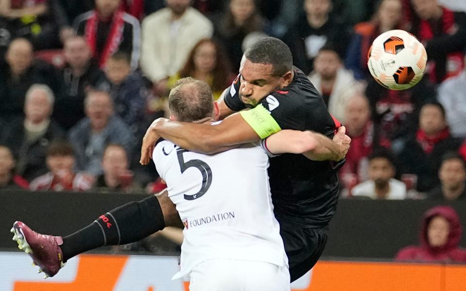 Jonathan Tah is challenged by Vladimir Coufal