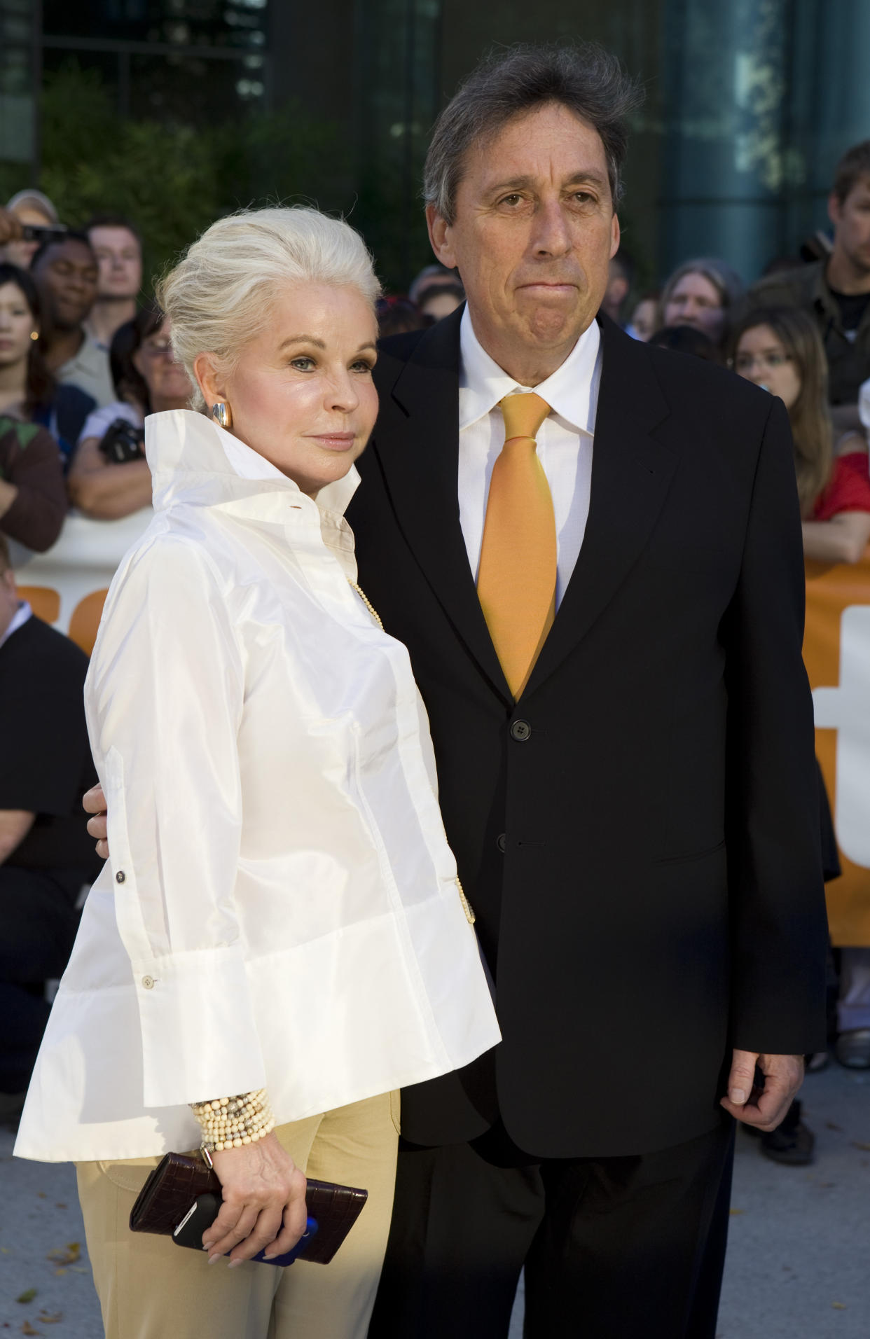 FILE - Ivan Reitman and wife Genevieve Robert arrive to the red carpet for the gala screening of "Chloe" during the Toronto International Film Festival at Roy Thomson Hall in Toronto, on Sept. 13, 2009. Reitman, the influential filmmaker and producer behind beloved comedies from “Animal House” to “Ghostbusters,” has died.  Reitman passed away peacefully in his sleep Saturday night, Feb. 12, 2022, at his home in Montecito, Calif., his family told The Associated Press.  He was 75.v (Sean Kilpatrick/The Canadian Press via AP, File)