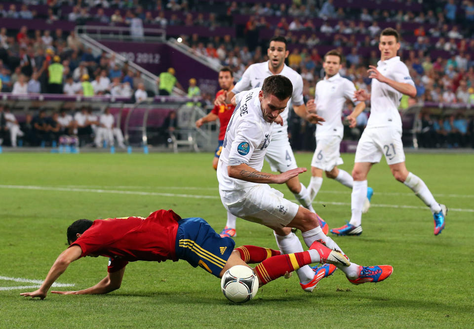 DONETSK, UKRAINE - JUNE 23: Anthony Reveillere of France tackles Pedro of Spain, resulting in a penalty during the UEFA EURO 2012 quarter final match between Spain and France at Donbass Arena on June 23, 2012 in Donetsk, Ukraine. (Photo by Alex Livesey/Getty Images)