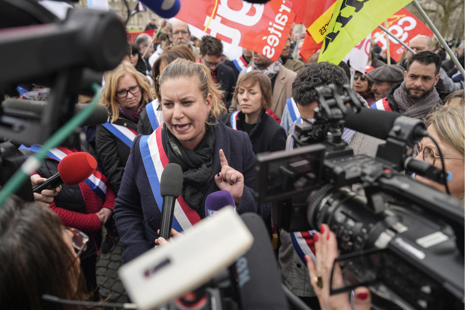 Lawmaker and far-left group leader Mathilde Panot gestures as she speaks to the media during a protest against the retirement bill in Paris, Monday, March 20, 2023. France's government is fighting for its survival Monday against no-confidence motions filed by lawmakers who are furious that President Emmanuel Macron used special constitutional powers to force through an unpopular bill raising the retirement age from 62 to 64 without giving them a vote. (AP Photo/Lewis Joly)