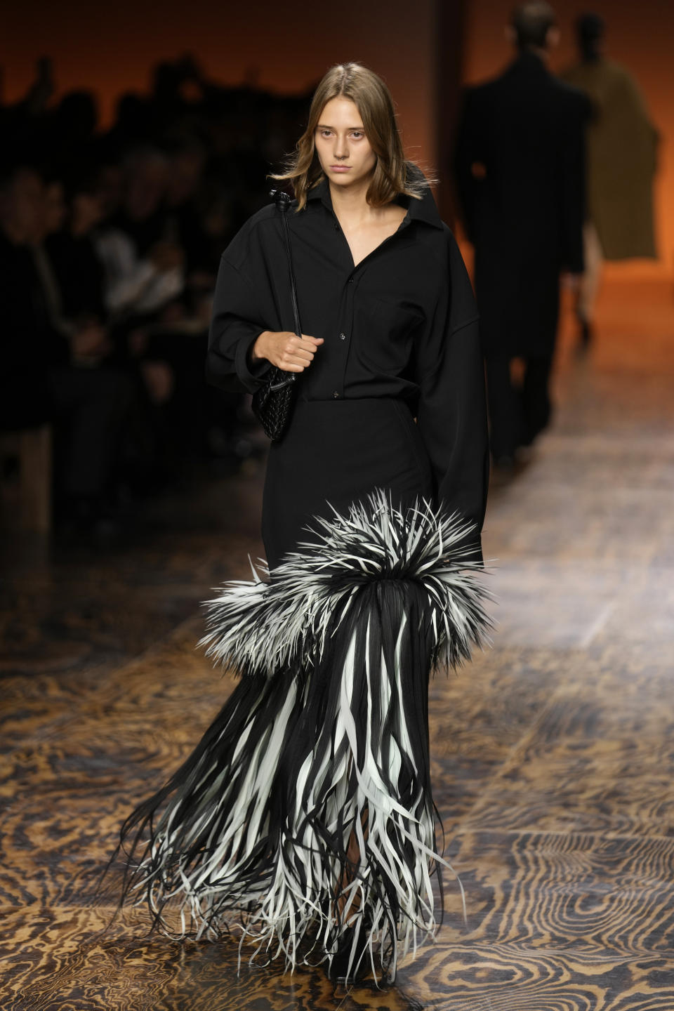 A model wears a creation as part of the Bottega Veneta women's Fall-Winter 2024-25 collection presented in Milan, Italy, Saturday, Feb. 24, 2024. (AP Photo/Luca Bruno)