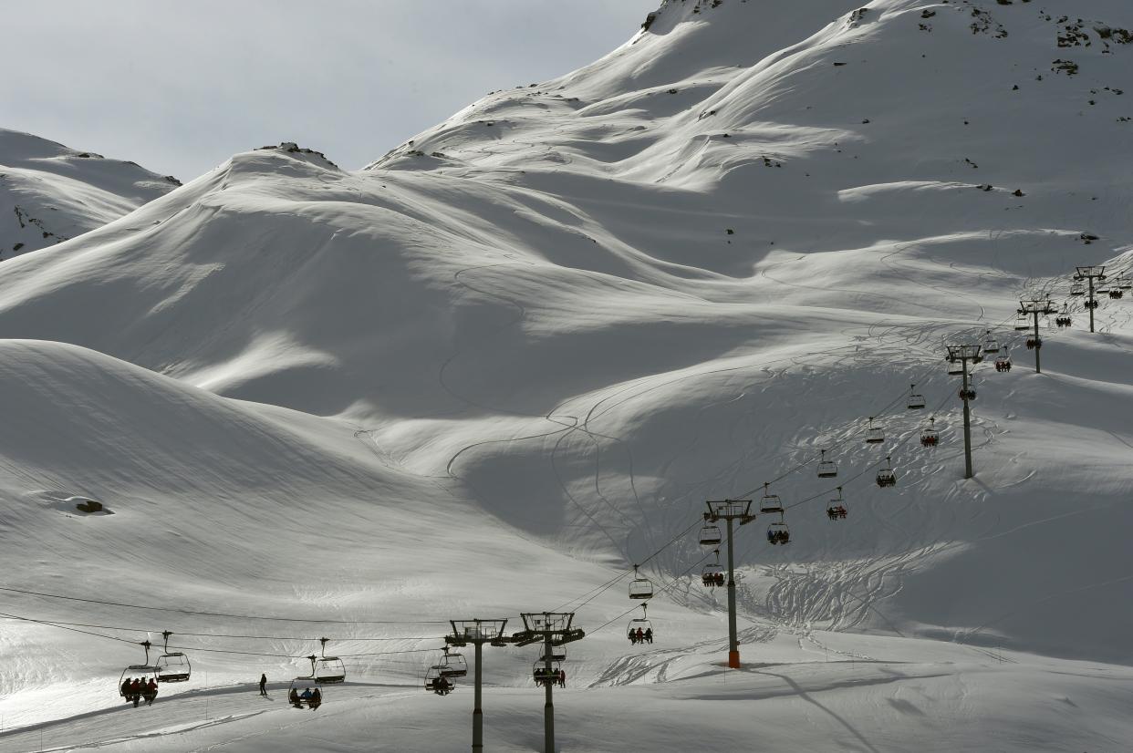 Skiers ride a chairlift on February 2, 2016 in the French ski resort of Meribel in the 3 Valleys ski area, the world's largest ski area, in central French Alps. 
French ski resorts prepare for the French winter school holidays' rush that will start on February 6. / AFP / PHILIPPE DESMAZES        (Photo credit should read PHILIPPE DESMAZES/AFP via Getty Images)