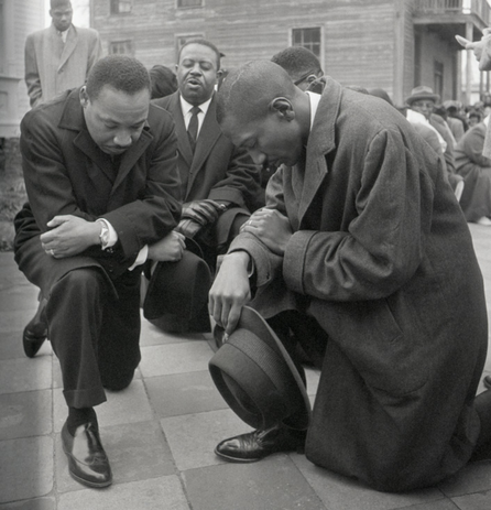 Civil rights leader Martin Luther King Jr. kneels with a group in prayer prior to going to jail in Selma, Alabama. (Getty Images)