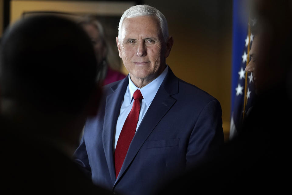 Former Vice President Mike Pence greets people while signing copies of his book "So Help Me God" before the start of a GOP fundraising dinner, Thursday, March 16, 2023, in Keene, N.H. (AP Photo/Steven Senne)