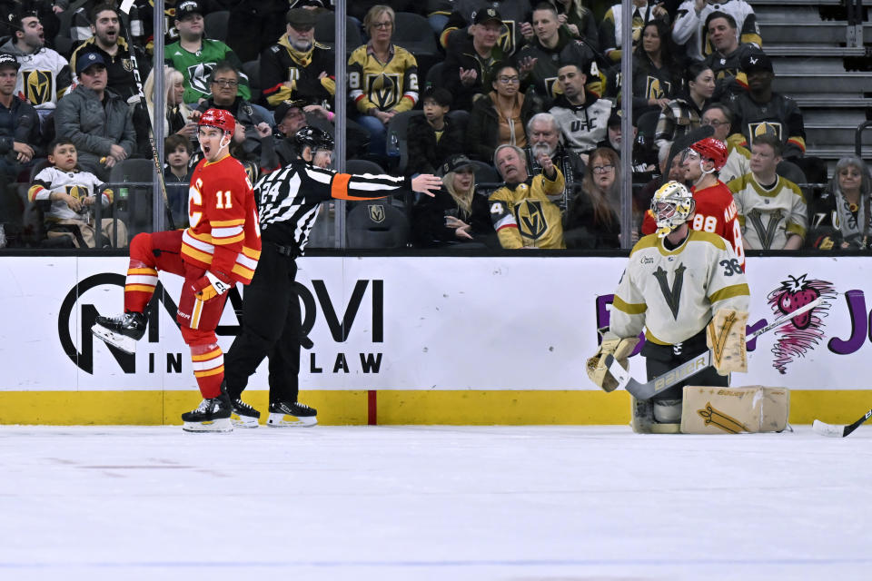 Calgary Flames center Mikael Backlund (11) celebrates a goal against Vegas Golden Knights goaltender Logan Thompson during the second period of an NHL hockey game Saturday, Jan. 13, 2024, in Las Vegas. (AP Photo/David Becker)