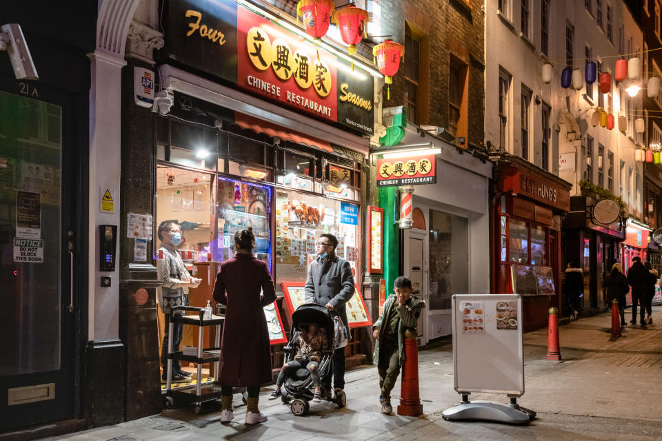 LONDON, ENGLAND - DECEMBER 20:  People order takeout at restaurants in Chinatown on December 20, 2020 in London, England.  London and the South East enter a 'Tier 4' lockdown as a new coronavirus strain is detected in the lead up to Christmas. (Photo by Joseph Okpako/Getty Images)