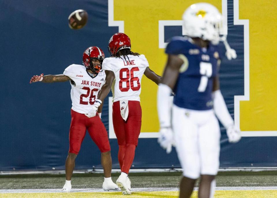 Jacksonville State running back Ron Wiggins (26) celebrates with wide receiver Quinton Lane (86) after scoring a touchdown against the FIU Panthers in the first half of an NCAA DI football game at the FIU Football Stadium on Wednesday, Oct. 25, 2023, in Miami, Fla.