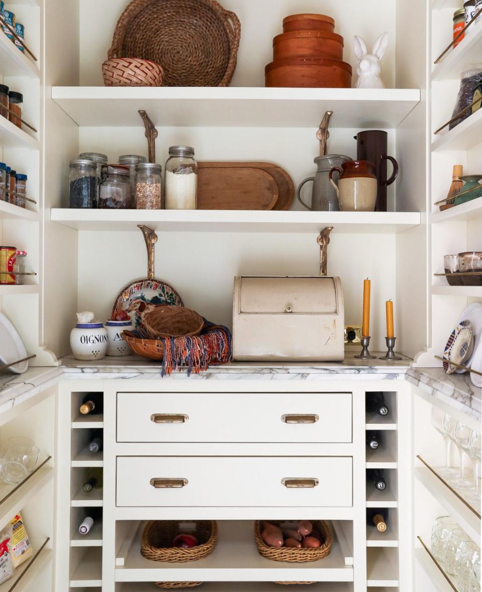 walk in pantry spices, dishware, and even a selection of wines are on display just steps from the main kitchen