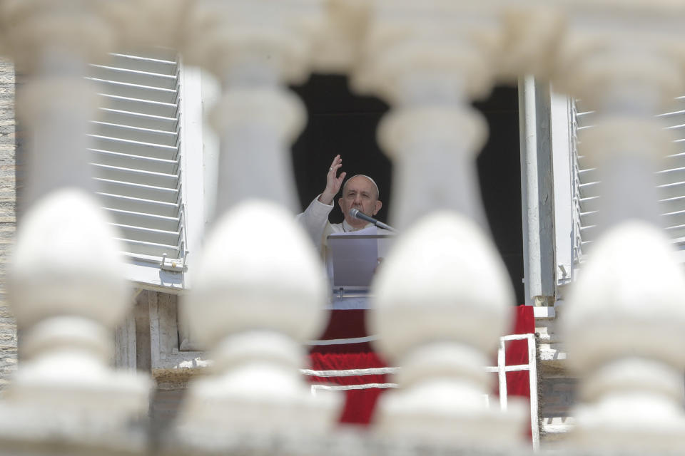 Pope Francis delivers his blessing as he recites the Angelus noon prayer from the window of his studio overlooking St.Peter's Square, at the Vatican, Sunday, June 7, 2020. Pope Francis is cautioning people in countries emerging from lockdown to keep following authorities’ rules for COVID-19 contagion containment. Says Francis: “Be careful, don’t cry victory, don’t cry victory too soon.” (AP Photo/Andrew Medichini)