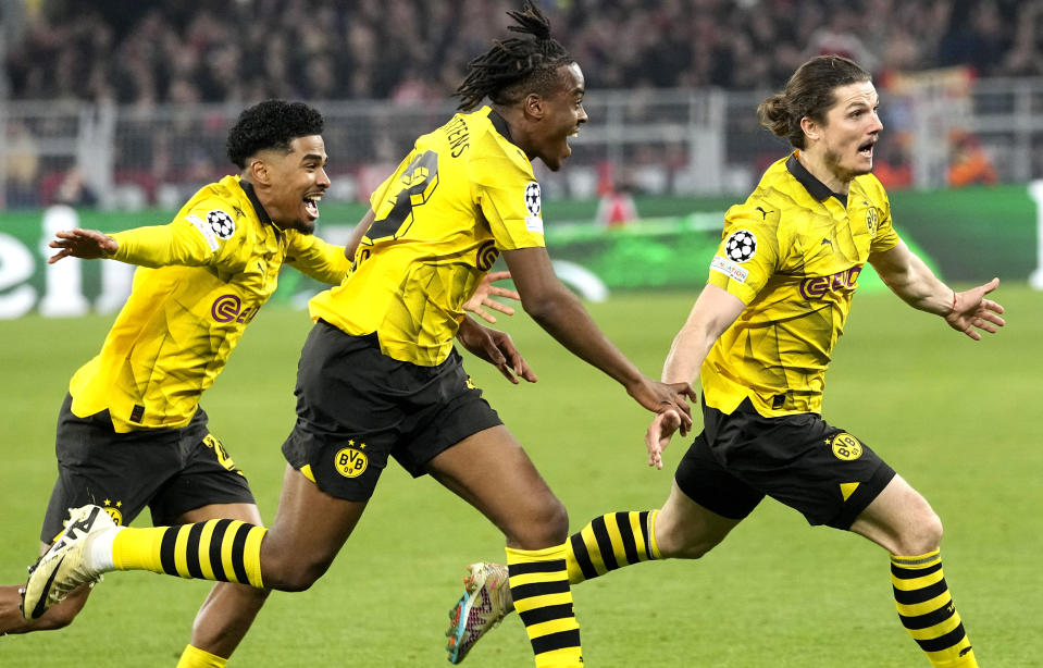 Dortmund's Marcel Sabitzer, right, celebrates his side's 4th goal during the Champions League quarterfinal second leg soccer match between Borussia Dortmund and Atletico Madrid at the Signal-Iduna Park in Dortmund, Germany, Tuesday, April 16, 2024(AP Photo/Martin Meissner)