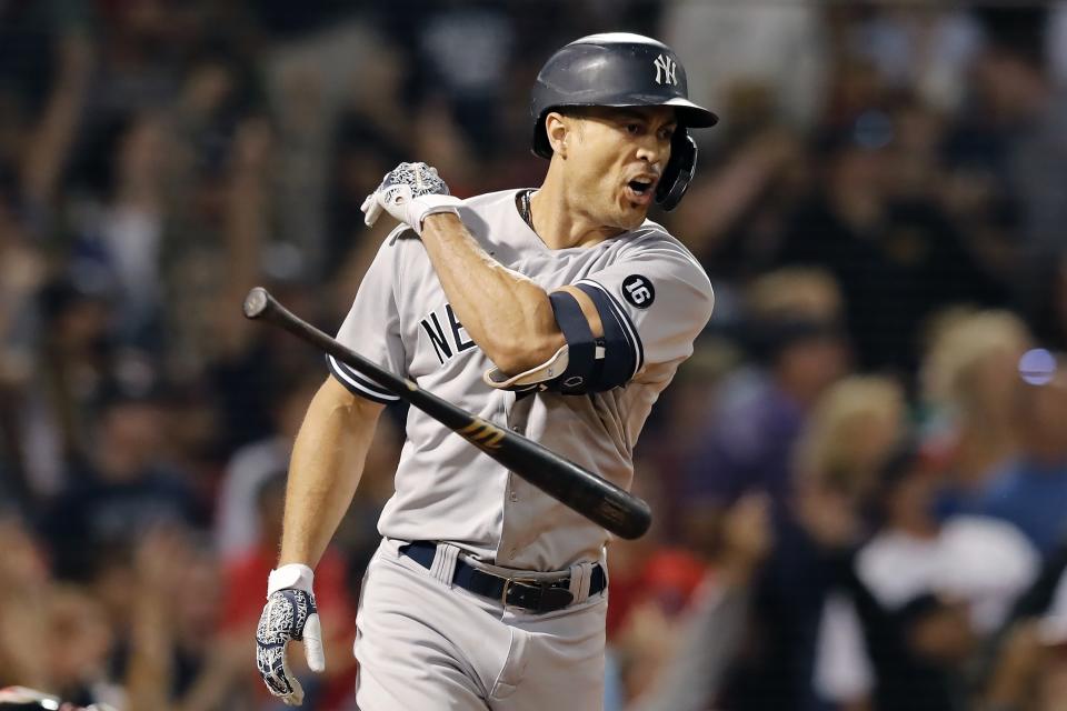 New York Yankees' Giancarlo Stanton tosses his bat after hitting a grand slam during the eighth inning of a baseball game against the Boston Red Sox, Saturday, Sept. 25, 2021, in Boston. (AP Photo/Michael Dwyer)