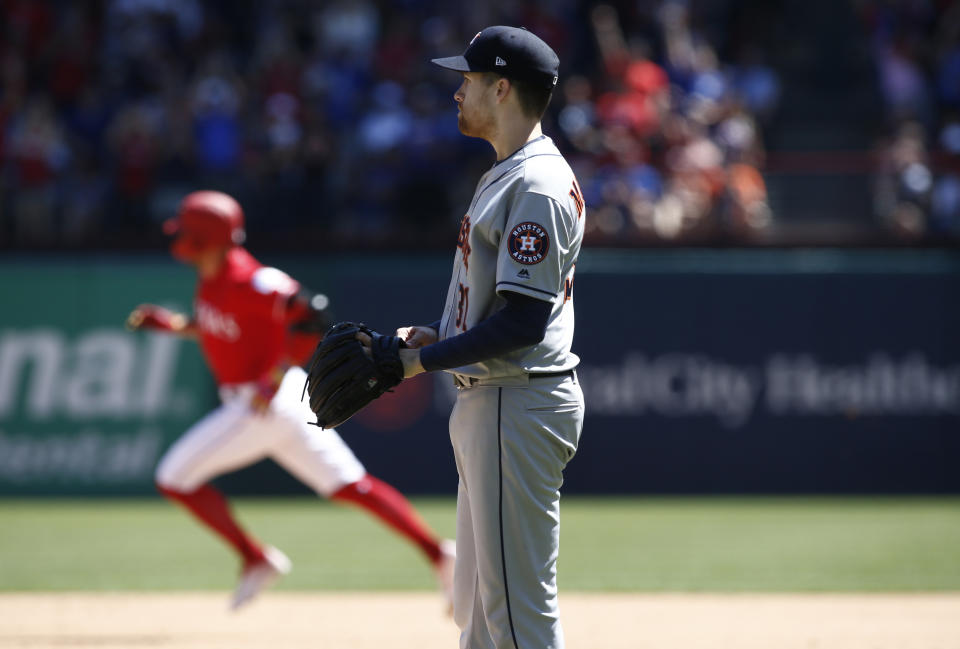 Houston Astros starting pitcher Collin McHugh looks towards the outfield as Texas Rangers' Hunter Pence (24) rounds the bases after hitting a home run during the third inning of a baseball game Sunday, April 21, 2019, in Arlington, Texas. (AP Photo/Mike Stone)