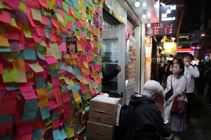 Protesters queue for a free Christmas dinner offered by a local restaurant in Hong Kong