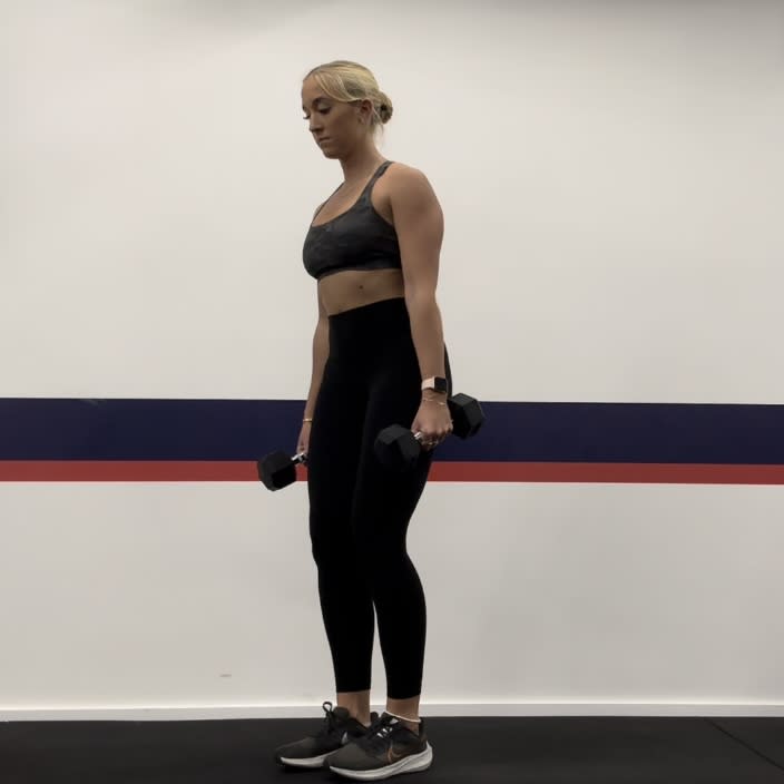 Personal trainer Klaudia Lucia demonstrating a dumbbell reverse lunge