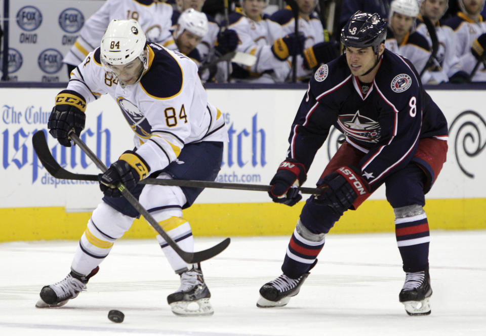 Buffalo Sabres' Philip Varone, left, carries the puck across the blue line as Columbus Blue Jackets' Nathan Horton defends during the third period of an NHL hockey game, Saturday, Jan. 25, 2014, in Columbus, Ohio. The Sabres won 5-2. (AP Photo/Jay LaPrete)