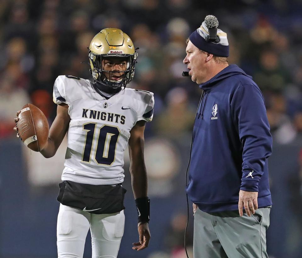 Hoban quarterback Tylan Boykin, left, listens to coach Tim Tyrrell during the second half.