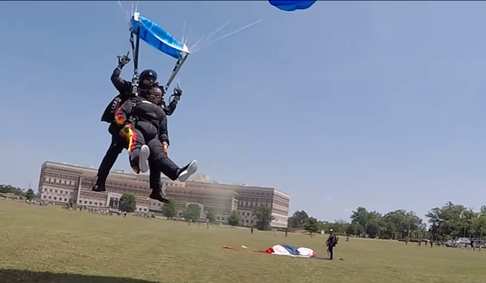 Bowley Elementary School Principal Latonya Leeks, front, and retired Master Sgt. Sunnydale Hyde, with All Veteran Group, prepare to touchdown after skydiving into Polo Field on Fort Bragg on Friday, May 12, 2023.