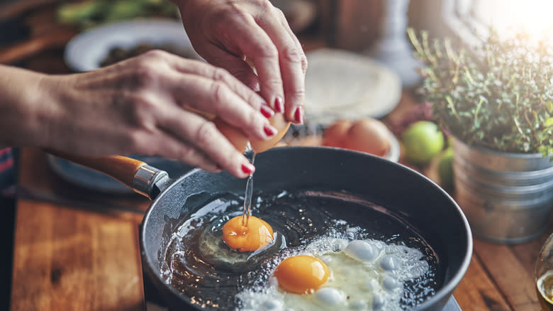 eggs being cracked into pan